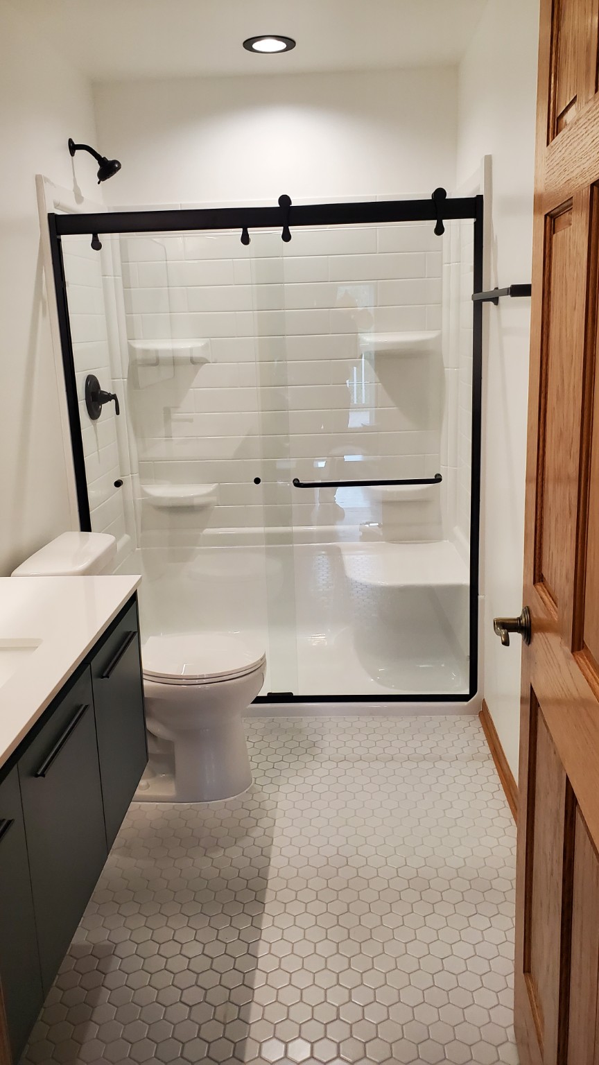 Walk-in shower with black-framed glass door